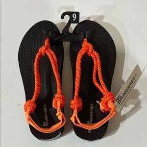 No Boundaries Black Sandals with Bright Orange Accents